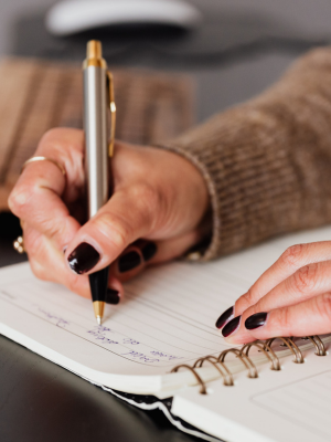 Woman's hands over a calendar planning out her day